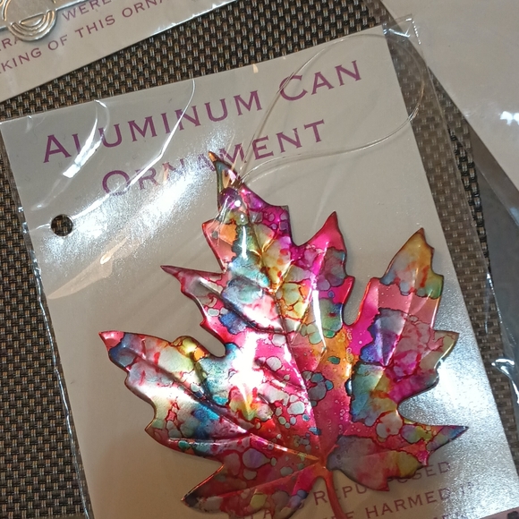 These painted ornaments are recycled tin cans. - Picture 3 of 3